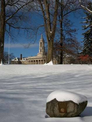 Penn State Old Main with plaque and snow