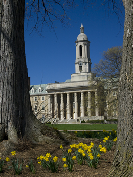 Old Main at Penn State with flowers